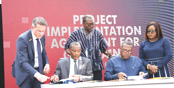 Dr Ben D.K Asante (2nd from right), Chief Executive Officer of Ghana National Gas Company, and Dr Hilton John Mitchell (2nd from left), a representative of the CMILT Consortium, signing the project implementation agreement. Looking on are Olarf Berkarkof (left), General Manager of the consortium, Sylvia Assimeng Archer (right) and Robert Kofi Lartey (in smock), both officials of Ghana Gas. Picture: EBOW HANSON 