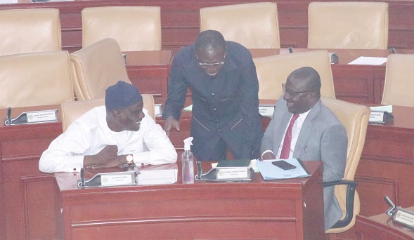 Haruna Iddrisu  (left), immediate past Minority Leader, conferring with  Andrew Asiamah Amoako (right), the Second Deputy Speaker of Parliament, during proceedings on the floor of the House yesterday
