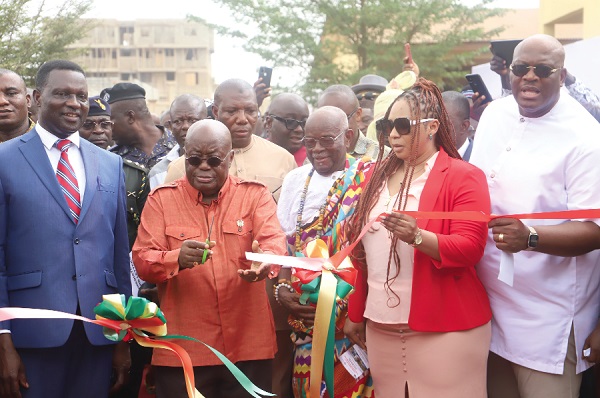 President Akufo-Addo (2nd from left) cutting a ribbon to inaugurate the kindergarten facility. With him are other government officials.   Picture: SAMUEL  TEI ADANO