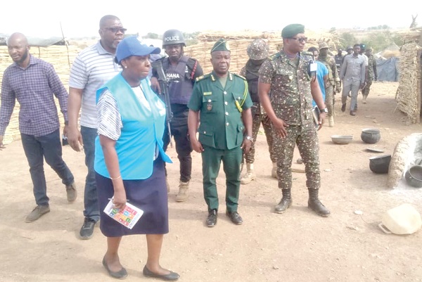 Esther Kiragu (left), UNHCR Country Representative, being led to inspect the temporary camp at Kare.­­