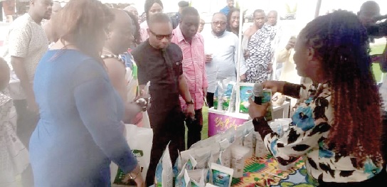 • Nana Kodwo Conduah (2nd from left), Paramount Chief of Elmina; Samuel Dentu (3rd from left), the Deputy CEO of GEPA, and Solomon Ebo Appiah, MCE, KEEA, looking at some of the products on exhibition
