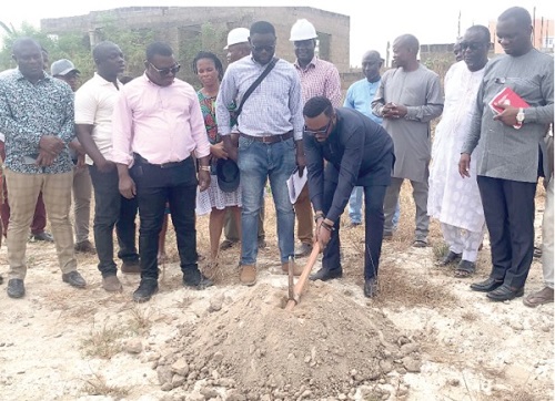 Clement Nii Lamptey Willkinson (with the axe), Municipal Chief Executive, Ga West, cutting the sod for the construction of the four-storey Kayayei hostel facility: File photo