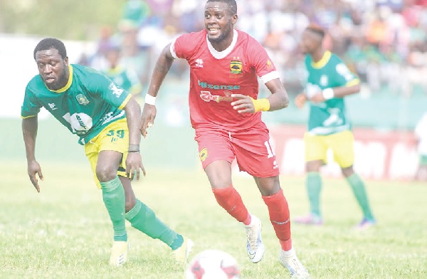 • Kotoko’s George Mfegue (right) gazes as he advances with the ball after beating his marker
