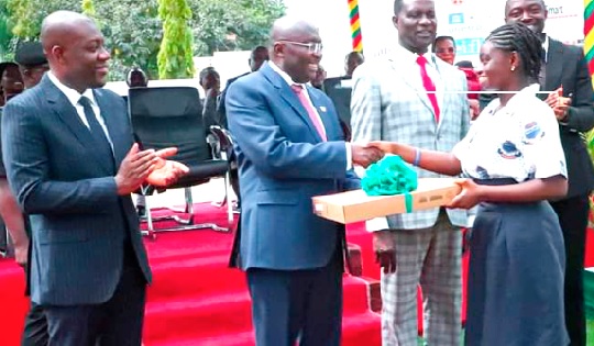 • Dr Mahamudu Bawamia (2nd from left),  the Vice-President, presenting a laptop to Christine Assan. Looking on are Dr Yaw Osei Adutwum (2nd from right), Minister of Education, and  Kojo Oppong Nkrumah (left), Minister of Information