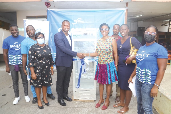 Dr Dennis Oteng (4th from left), Chief Executive Officer of Ravens Consulting, presenting the blood bank refrigerator to Dr Mame Yaa Nyarko (4th from right), Medical Superintendent of the Princess Marie Louis Hospital in Accra. Those with them are some staff of Ravens Consulting and the hospital. Picture: GABRIEL AHIABOR