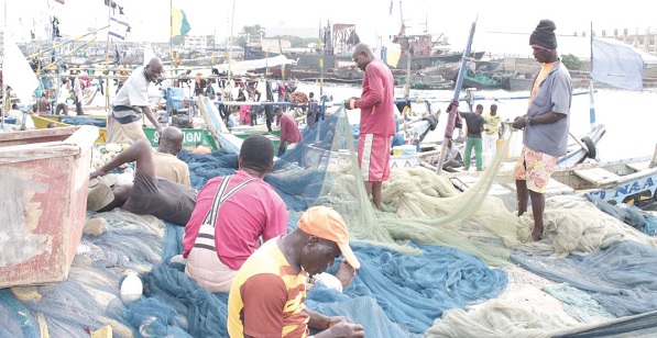 Fishermen mending their nets at a Landing Beach site