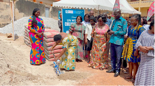  Theodosia Jackson (with shovel) cutting the sod for work to start on the project. With her is Clara Puni Nyamesem (3rd from left), Executive Director of Child and Family Life International, and other officials of the school