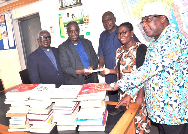 Rev. Dr Setri Nyomi (2nd from left) presenting the books to Dr Amy Asimah while others look on