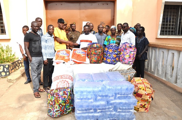 David Kwaku Danku (middle), presenting the items to Deputy Superintendent of Prisons Sylvester Fiadzigbe (third left) while others look on