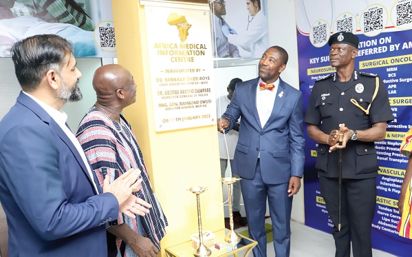 Dr Okoe Boye (2nd from right), CEO, NHIS, being assisted by Brig, General Raymond Ewusi (2nd from left), Director General, Ghana Armed Forces Medical Services, to unveil the Klinik. With them are COP Paul Awini (right), Director General, Police Patrol, and Jignesh Viradia (left), CEO, Africa Medical Information Centre. Picture: SAMUEL TEI ADANO