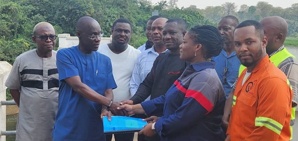 The Chief Manager of the project, Ing. Francis Adjei – Boateng, from the GWCL presenting the contract to Q3 General Construction and Civil Engineering Dredging Works Limited, being led by Mrs. Leonara Appiah.