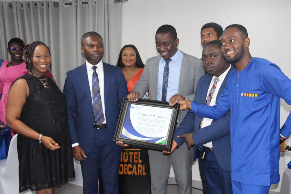 Dr Richard Odor (2nd from left), Chief Executive Officer, Top-Up Pharmacy being presented with a citation from staff and management members of Top-Up Pharmacy at an awards and dinner at Tema. Picture: SAMUEL TEI ADANO