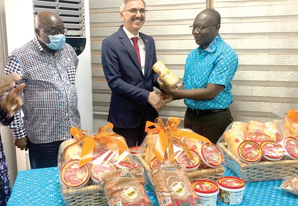 Ken Ofori-Atta (right), Minister of Finance, presenting the cocoa products to Hüseyin Güngör (middle), the Türkiye Ambassador. Looking on is Dr Kwaku Owusu Baah (left), the Board Chair of the Cocoa Processing Company