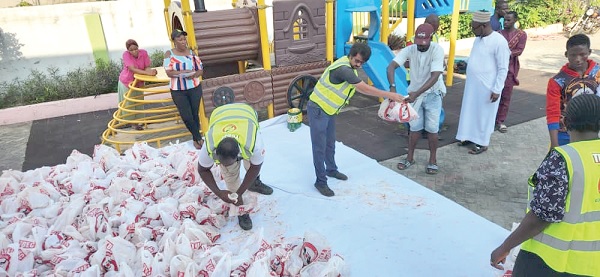 Some members of TUDEC giving out parcels of meat to some beneficiaries