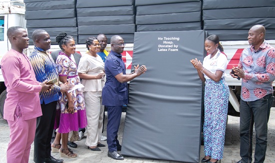 Gifty Ekeocha Appiah (2nd from right) presenting the items to Prof. Yaw Asante Awuku at the ceremony while other staff of Latex Foam and the Ho Teaching Hospital look on