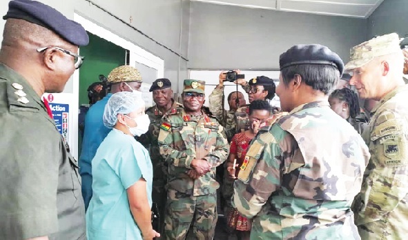 Major General Todd Wasmund (2nd from right), Commander of the US Army Southeastern Europe Task Force - Africa, interacting with a medic from the US Army