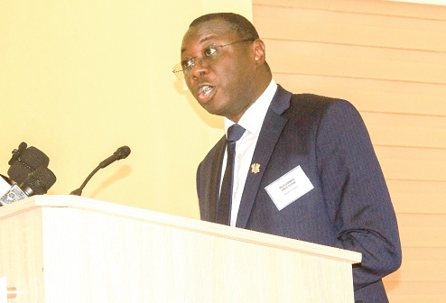 Mohammed Amin Adam (inset), Minister of State at the Ministry of Finance, delivering his address at the conference. Picture: ERNEST KODZI