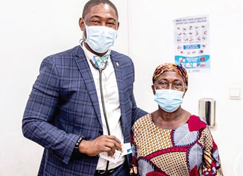  Dr Bernard Okoe Boye, CEO of the National Health Insurance Authority, with a subscriber of the National Health Insurance Scheme who depend on the service for health care