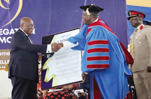 Prof. William Kofi Koomson (right), Vice-Chancellor, VVU, presenting a citation to President Akufo-Addo at the 1st Special Congregation at Valley View University at Oyibi.  Picture: SAMUEL TEI ADANO