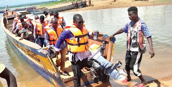 Osei Bonsu, the Krachi West District Chairman of GNAT, with other officials coming off the canoe