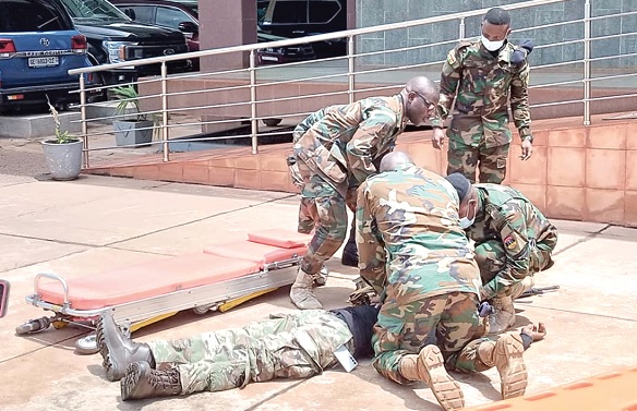 A wounded soldier being attended to by colleagues during the simulation exercise
