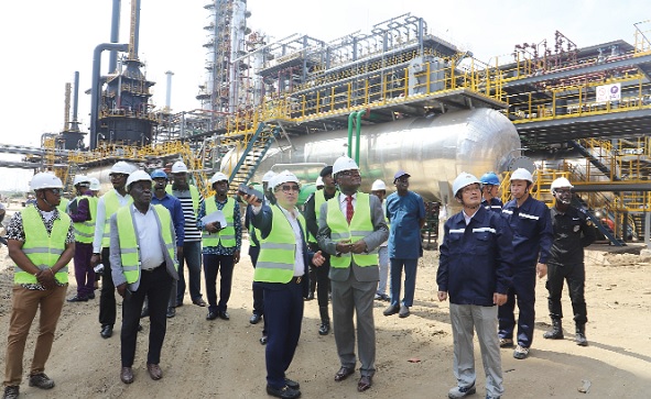 Xu Gingguang (arrowed), Group Chairman, Sentuo Oil Refinery, briefing Kobina Tahir Hammond, Minister of Trade and Industry, on the operations of the facility during the tour in Tema. Picture: SAMUEL TEI ADANO