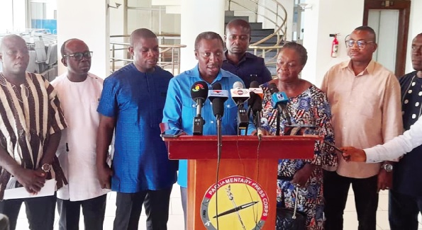 Alexander Afenyo-Markin (middle) reading a joint statement issued by the members of the committee