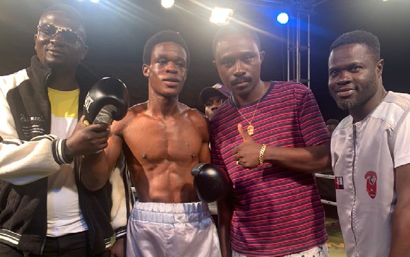 Stanley Nyantakyi (2nd left) with his manager, Gordon Frimpong (2nd right) after his win last Saturday