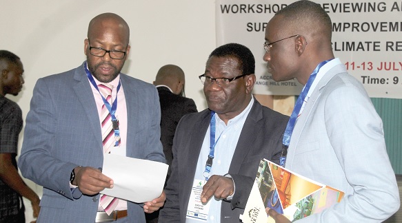 Dr Ernest Afiesimama (middle), Regional Programme Manager, World Meteorological Organisation, interacting with some participants in the workshop in Accra.  Picture: ESTHER ADJORKOR ADJEI