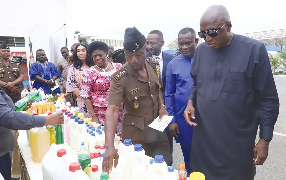 William Afari (3rd from right), a Deputy Commissioner of Prisons, briefing Ambrose Dery (right), Minister for the Interior, on the benefits of the products to the economy. With them are John Kumah (2nd from right), Deputy Minister of Finance, and Kofi Ofosu Nkansah (behind them), CEO, NEIP. Picture: SAMUEL TEI ADANO