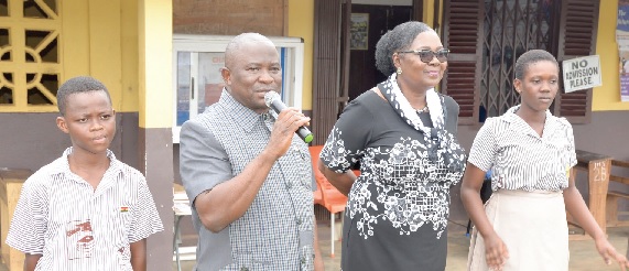 Alexander Akwasi Acquah (2nd from left) addressing some of the candidates during the tour. With him are Esther Quaye-Sowah (2nd from right), the Municipal Director of Education, and some BECE candidates