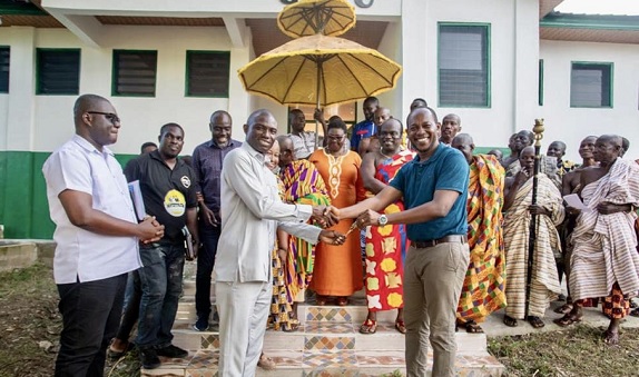 Thomas Pinto (right), Project Consultant, presenting the keys of the 12-unit sanitary facility at Mando SHTS, to Dr Dominic Eduah (arrowed), Executive Director, GNPC Foundation, and Moses Antwi Benefo (left), Head of Media &amp; PR at GNPC Foundation