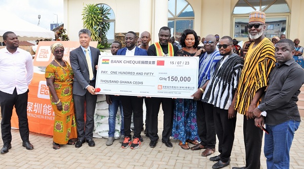 Qun Yang (3rd from left), Chairman of Sunon Asogli Power (Ghana) Limited, presenting the cheque for the seed money to some elders at the Asogli Palace and officials of the municipal assembly