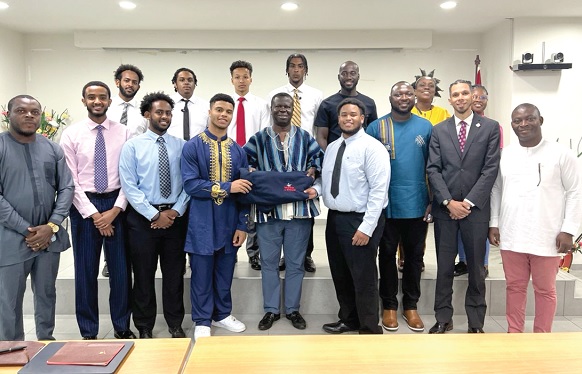 Dr Baffour Awuah (in smock), Director of Technical Coordination at MoH, with some officials and the students 