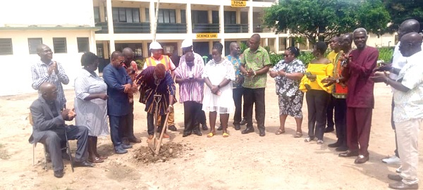 Daniel Biofio (holding pickaxe), National President of the Tema Old Students Association (TOSA), cutting the sod to kickstart the construction of the washroom facility. Looking on are members of the 1983 TOSA and Emmanuel Kobina Baidoo (in smock), Headmaster of Tema Senior High School