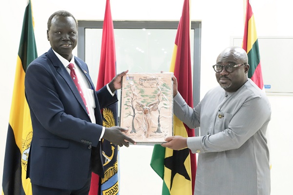 Lt. Gen. Biar Atem Ajang (left), Leader of the South Sudan Ministry of Defence and Veterans Affairs delegation, presenting an art of appreciation to Kofi Amankwa-Manu, Deputy Minister of Defence, after the meeting. Picture: EDNA SALVO-KOTEY