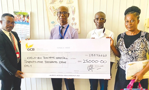 Emmanuel Agyei Arthur (left), Corporate Communications Manager of GCGL, presenting the cheque for the amount to  Dr Kenneth Baidoo (2nd from left), Head of the ENT Department at KBTH. With them are Hayford Asante, the patient, and Charity Asante Kissiedu, his wife 