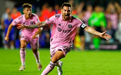 Lionel Messi celebrates his late winner for Inter Miami after converting a stoppage-time free-kick on his debut