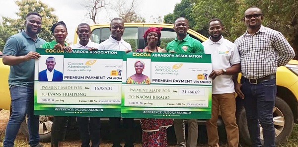 The two highest earners displaying their cheques
