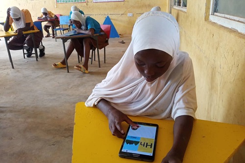 Some of the girls using the app to practise how to read