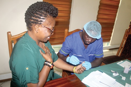 Yvonne Dasoberi (left), a staff of GCGL, being screened for Hepatitis ‘B’. Picture: ESTHER ADJORKOR ADJEI