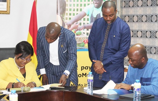 COP Maame Yaa Tiwa Addo Danquah (left), Executive Director of EOCO, and Shiabu Haruna (right), Chief Executive Officer of MTN Mobile Money Limited, signing the MoU 