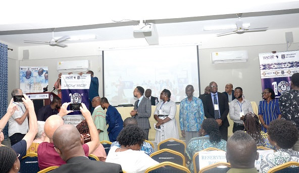 A banner being pulled down to unveil a logo to launch the 10th anniversary of WACCBIP. Looking on are members of the planning committee of the anniversary. Picture: ALBERTA MORTTY