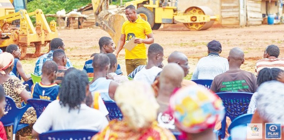 Raphael Godlove Ahenu (standing), CEO of GloMeF, speaking to some community members at Kyeredua