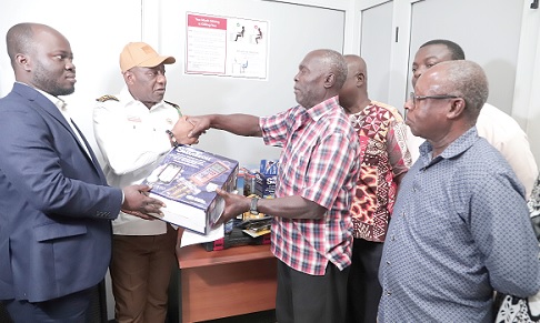 Dr Henry Kwabena Kokofu (2nd from left), Executive Director, Environmental Protection Agency, presenting the refrigeration tools and equipment to Solomon Quaye (2nd from right), National President of the National Air-conditioning and Refrigeration Workshop Owners Association. Those with them are Stephen Kansuk (left), Head of Climate Change, UNDP and some members of NARWOA. Picture: EDNA SALVO-KOTEY