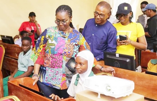 Ursula Owusu-Ekuful (arrowed),  Minister of Communications and Digitalisation, observing the young girls operating their computers