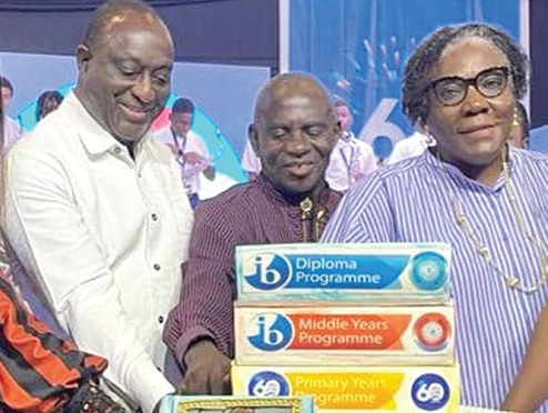 Abraham Dwuma Odoom (middle) former MP for Twifo Atti Morkwa, cutting the 60th anniversary cake. Looking on is Alan Kyeremateng and Audrey Doryumu, Headmistress of the school