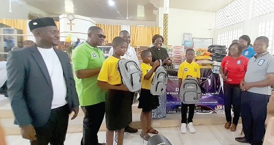 Bettina Hewlett-Bogart (2nd from right), Presbyter, presenting the items to the New Horizon Educational Centre. Looking on are representatives of the school