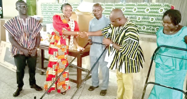 Seth Anim Boadi (2nd from right), Chairman of the Parents Association, prsenting the items to Golda Andam, Headmistress of SWESCO