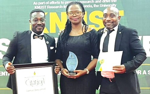 Emma Adwoa Appiaa  Osei-Duah (middle), Director, Communications and Corporate Affairs, Zoomlion, with the plaque while her colleagues display the citation and the certificate